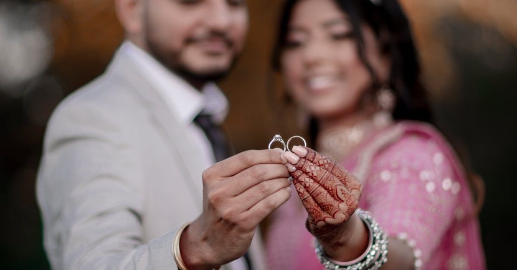 Indian bride and groom celebrating their wedding, holding rings, showcasing Indian culture.